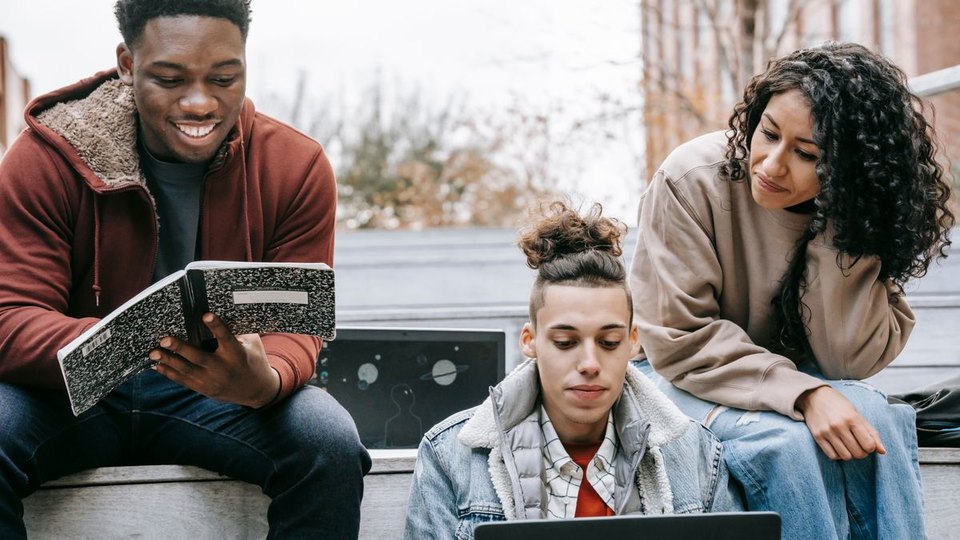 Young adults learning together outdoors