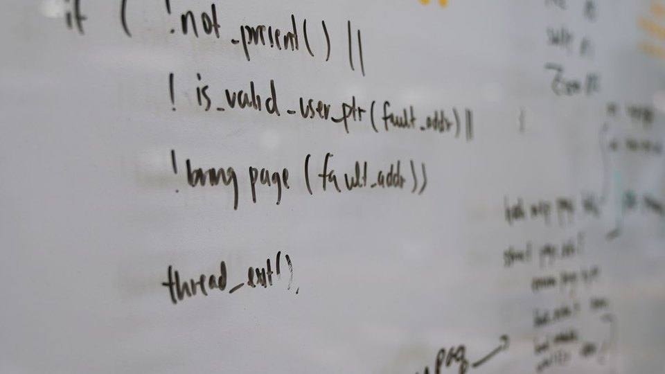 Handwritten programming logic on a whiteboard