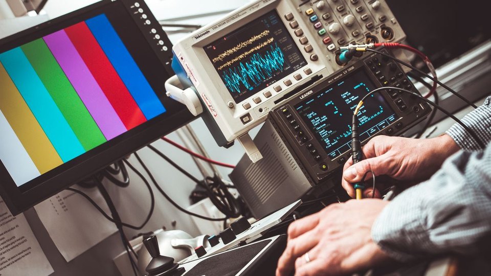 Technician operating electronic test equipment