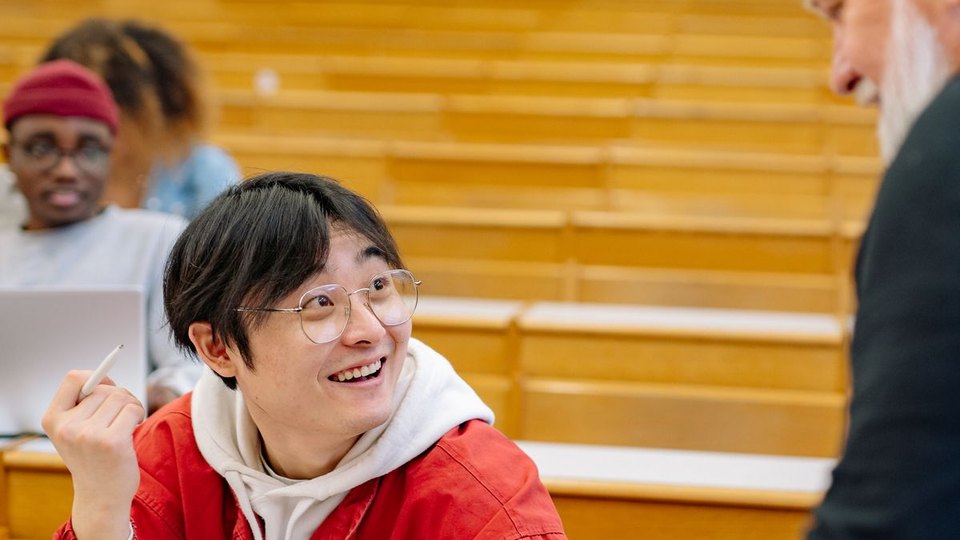 A professor and students in a lecture hall