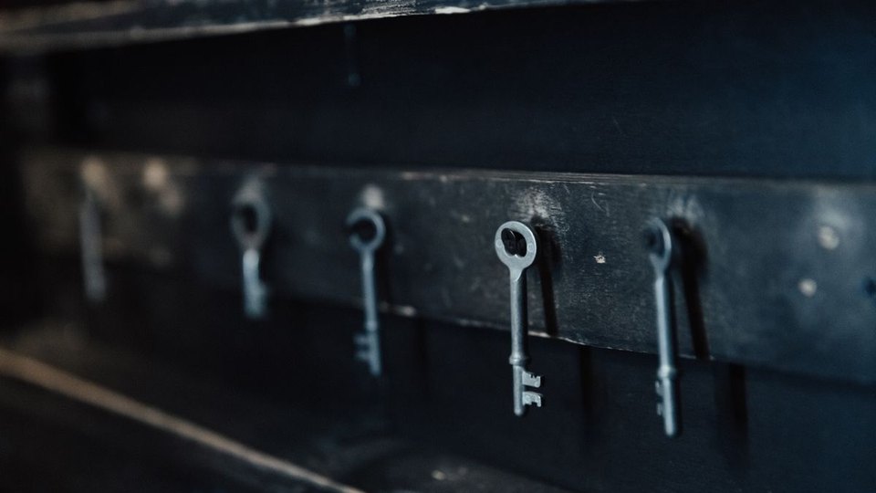 Separate metal keys hanging in a row