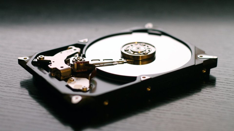 Open hard drive showing its internal mechanism