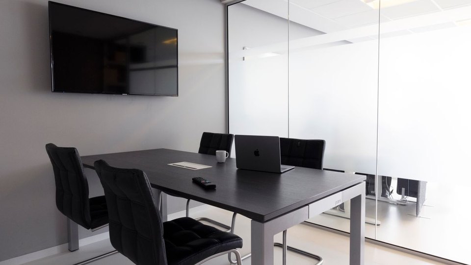 Modern meeting room with a table and display
