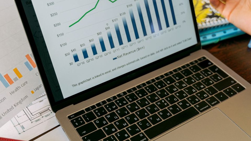 Laptop displaying business analytics and charts